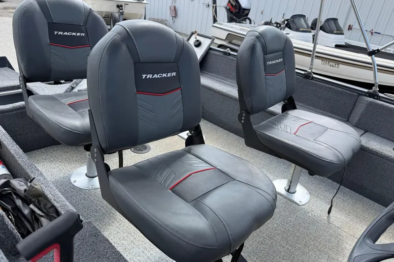 Slide: The Image of 2021 Tracker Pro Guide V-16 SC boat interior with gray cushioned seats. - 31