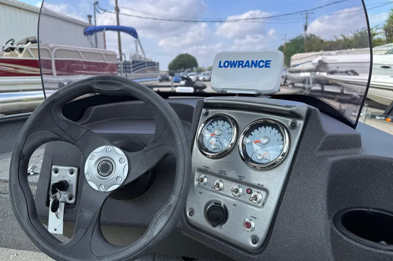 Slide: The Image of 2021 Tracker Pro Guide V-16 SC dashboard with steering wheel and gauges. - 32