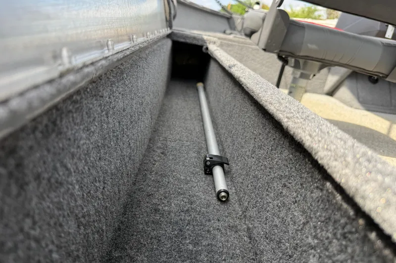Slide: The Image of 2021 Tracker Pro Guide V-16 SC boat interior storage compartment with rod holder. - 34