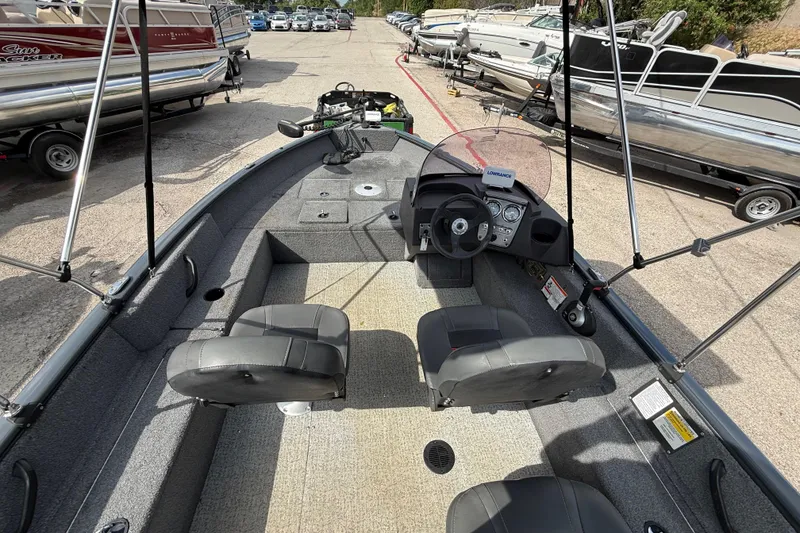 Slide: The Image of 2021 Tracker Pro Guide V-16 SC boat interior with steering console and seating. - 35