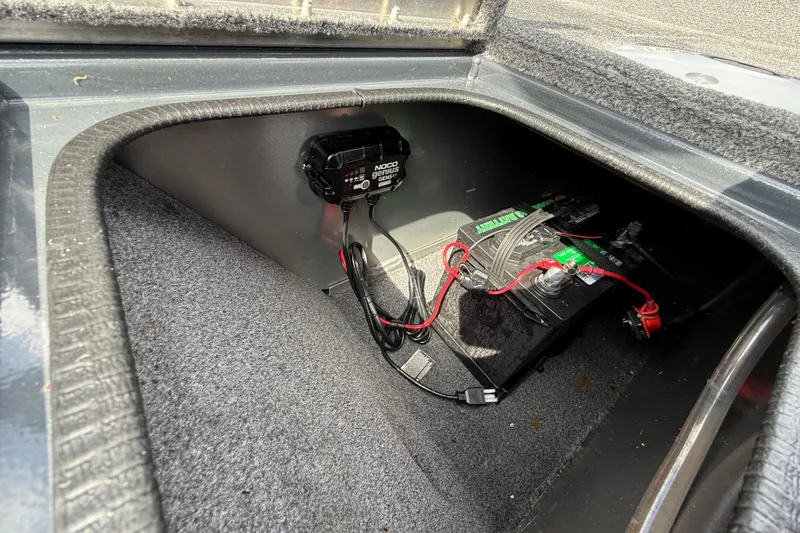 Slide: The Image of Battery compartment of 2021 Tracker Pro Guide V-16 SC with NOCO Genius charger. - 36