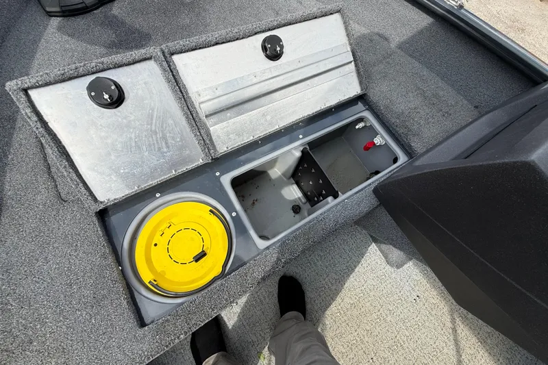 Slide: The Image of 2021 Tracker Pro Guide V-16 SC boat storage compartments with yellow lid and gray interior. - 38