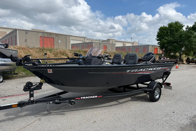 Slide: The Image of 2021 Tracker Pro Guide V-16 SC boat on trailer, parked outdoors under cloudy sky. - 40