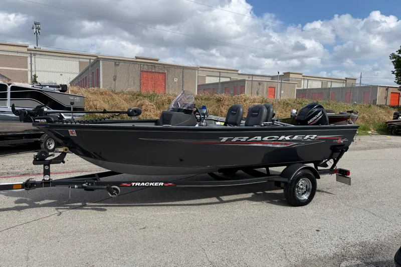 Slide: The Image of 2021 Tracker Pro Guide V-16 SC boat on trailer, parked outdoors under cloudy sky. - 41