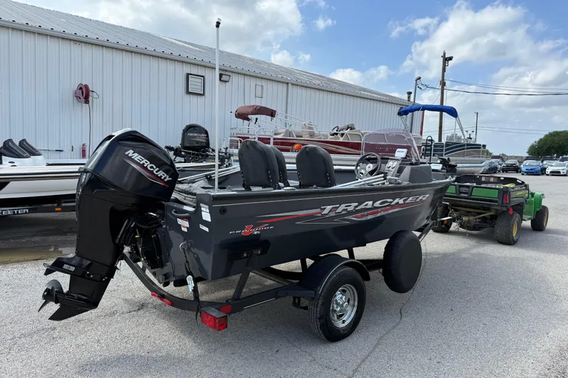 Slide: The Image of 2021 Tracker Pro Guide V-16 SC boat with Mercury engine on trailer, parked outdoors. - 43