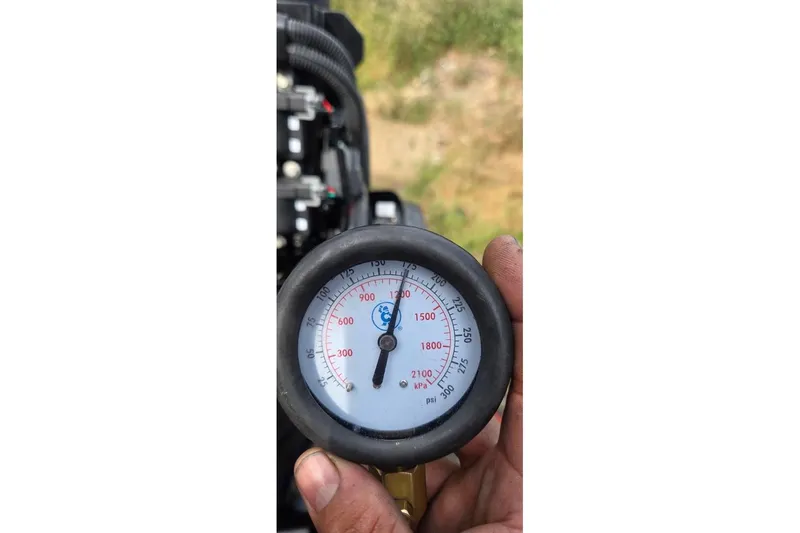 Slide: The Image of Close-up of a pressure gauge reading 2100 psi on a 2021 Tracker Pro Guide V-16 SC. - 47