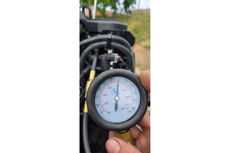 Slide: The Image of Pressure gauge reading on a 2021 Tracker Pro Guide V-16 SC boat engine. - 49