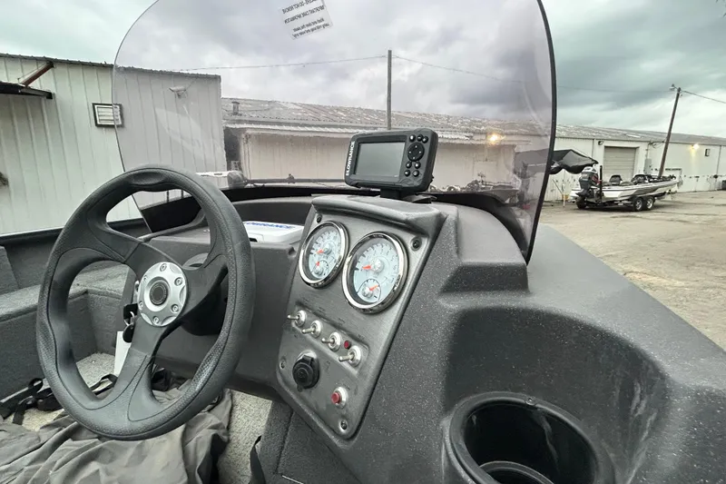Slide: The Image of 2021 Tracker Pro Guide V-16 SC boat dashboard with steering wheel and gauges. - 5