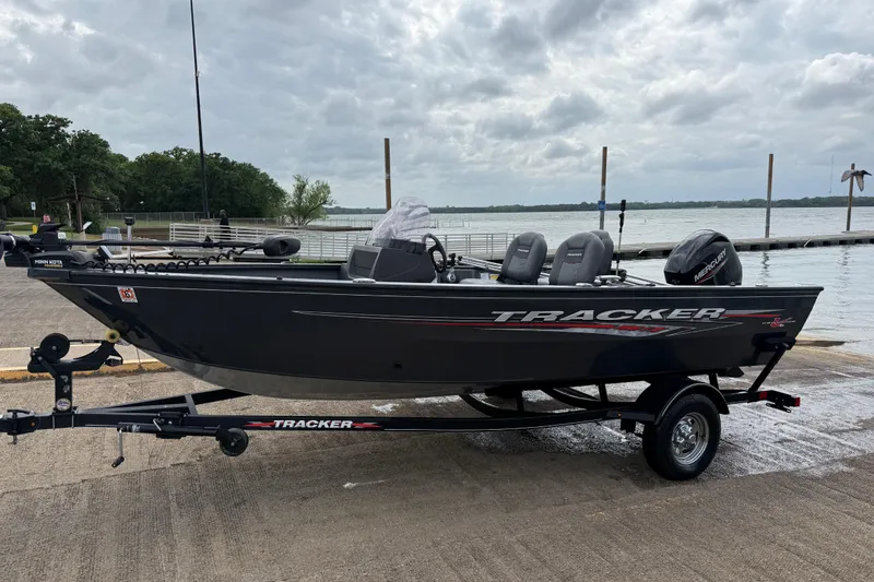 Slide: The Image of 2021 Tracker Pro Guide V-16 SC boat on trailer by a lake dock. - 51