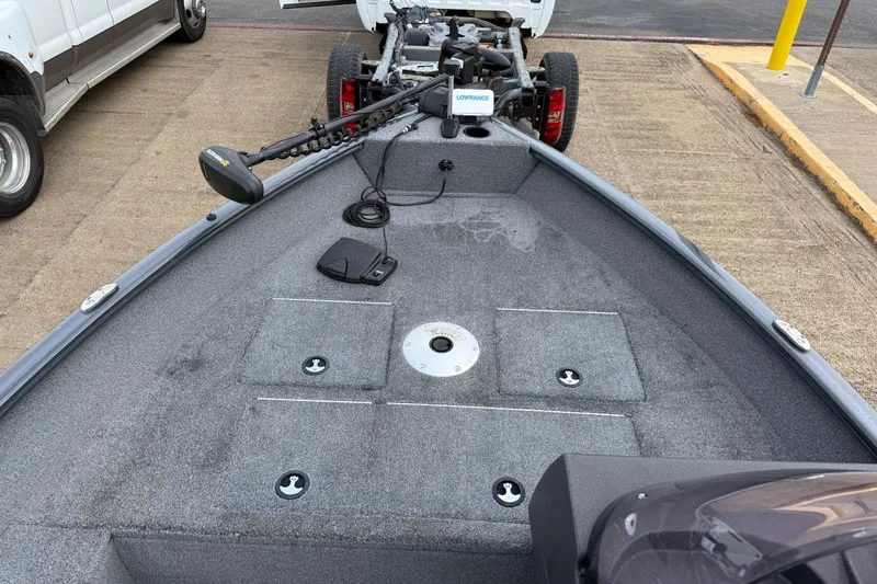 Slide: The Image of 2021 Tracker Pro Guide V-16 SC boat interior with trolling motor and carpeted deck. - 69