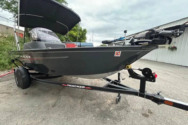 Slide: The Image of 2021 Tracker Pro Guide V-16 SC boat on trailer, featuring Minn Kota motor. - 7