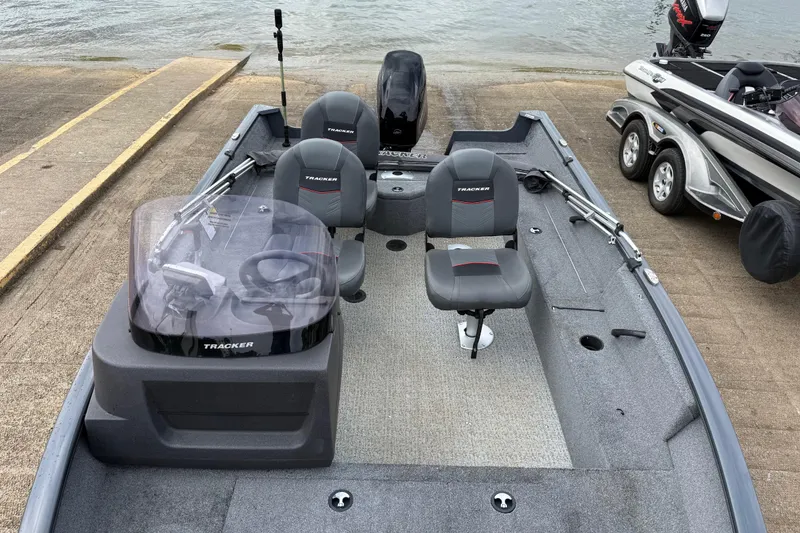 Slide: The Image of 2021 Tracker Pro Guide V-16 SC boat at a dock, featuring seating and steering console. - 70