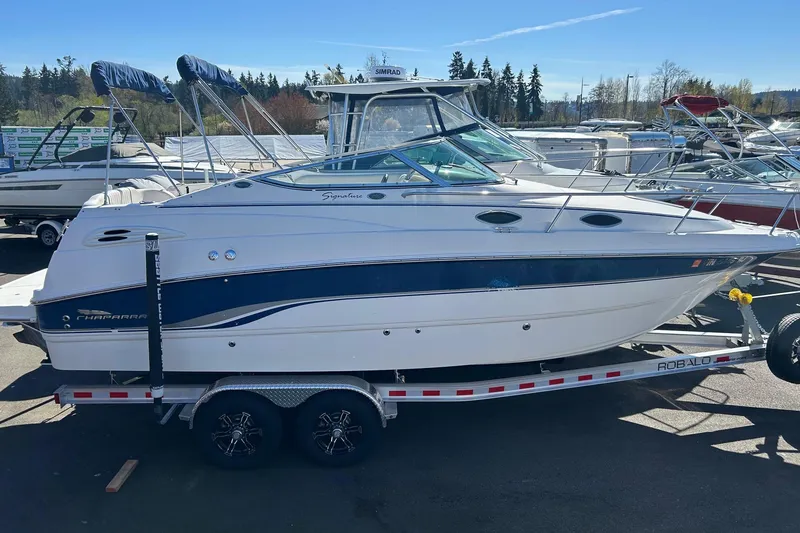 The Image of 2001 Chaparral Signature 240 boat on trailer, parked outdoors under clear sky. - 14