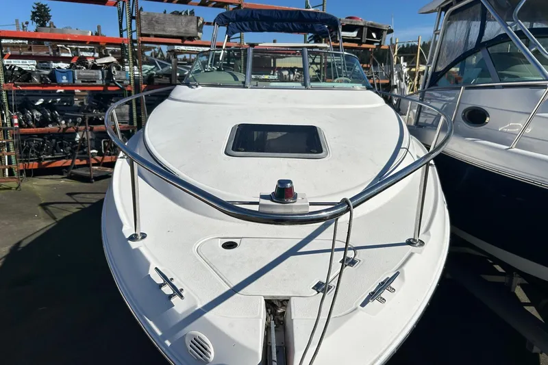 Slide: The Image of 2001 Chaparral Signature 240 boat docked, showcasing sleek design and spacious deck. - 16