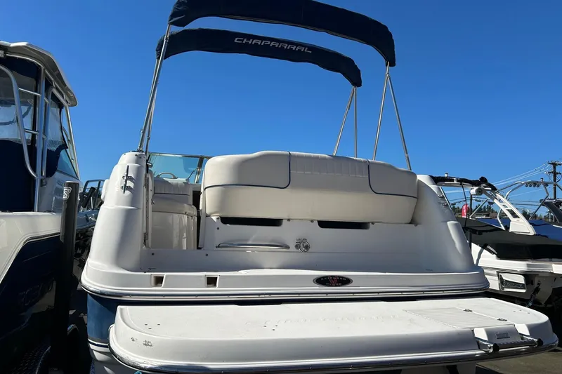 Slide: The Image of 2001 Chaparral Signature 240 boat with canopy, docked under clear blue sky. - 18