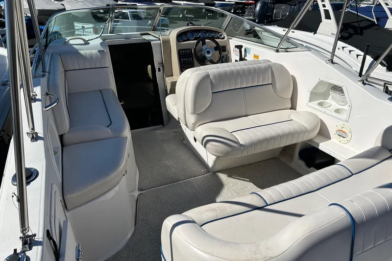 Slide: The Image of 2001 Chaparral Signature 240 boat interior with white seating and steering console. - 19