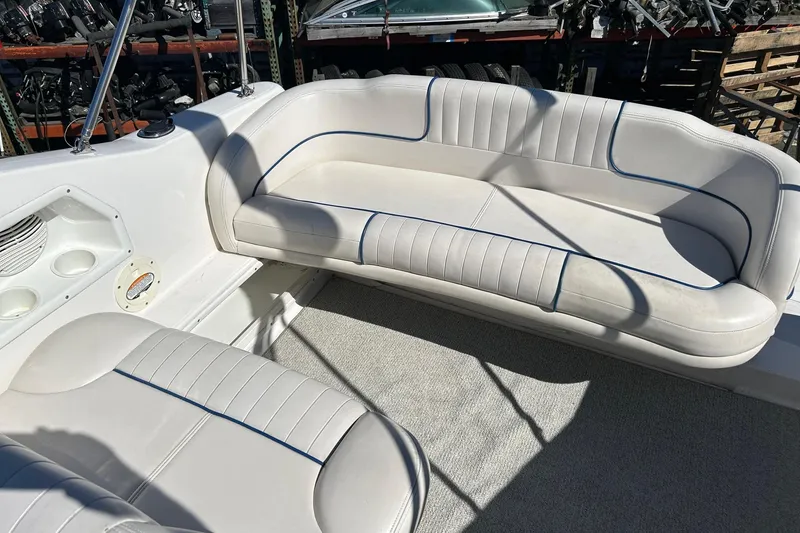 Slide: The Image of 2001 Chaparral Signature 240 boat interior with white cushioned seating and cup holders. - 20