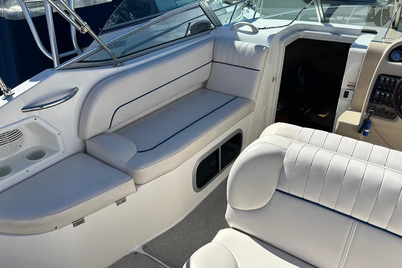 Slide: The Image of 2001 Chaparral Signature 240 boat interior with white seating and dashboard view. - 21
