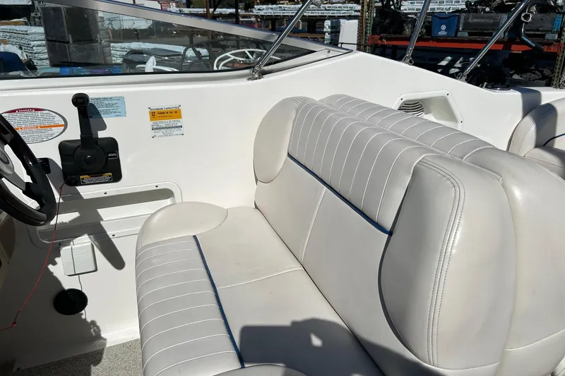 Slide: The Image of 2001 Chaparral Signature 240 boat interior with white seating and steering controls. - 23