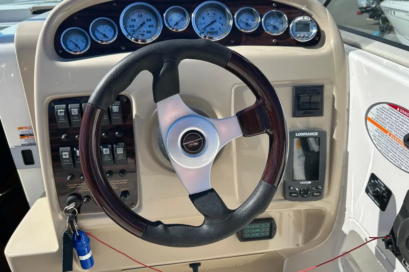 Slide: The Image of Steering wheel and dashboard of 2001 Chaparral Signature 240 boat with gauges and controls. - 24