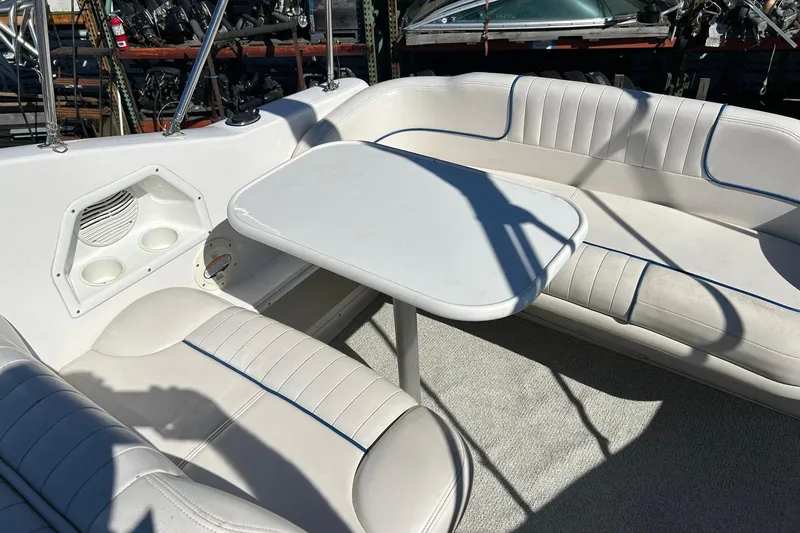 Slide: The Image of 2001 Chaparral Signature 240 boat interior with white seating and table. - 25