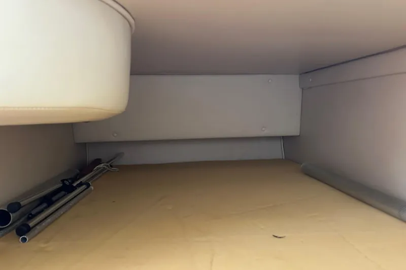 Slide: The Image of Interior cabin view of a 2001 Chaparral Signature 240 boat, featuring storage space. - 26