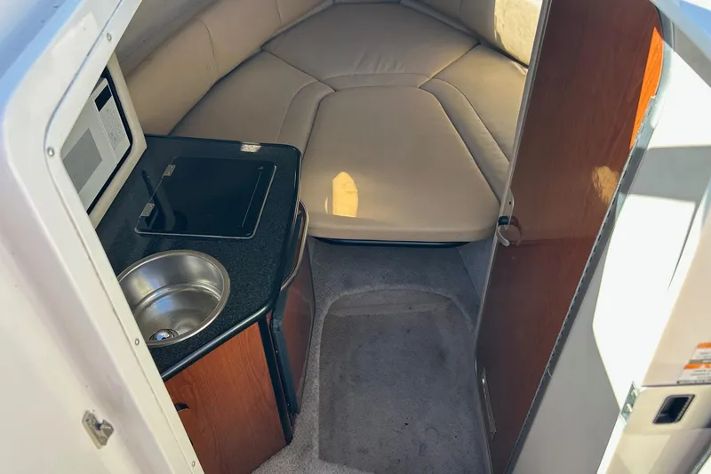 Slide: The Image of 2001 Chaparral Signature 240 cabin interior with kitchenette and cozy sleeping area. - 28