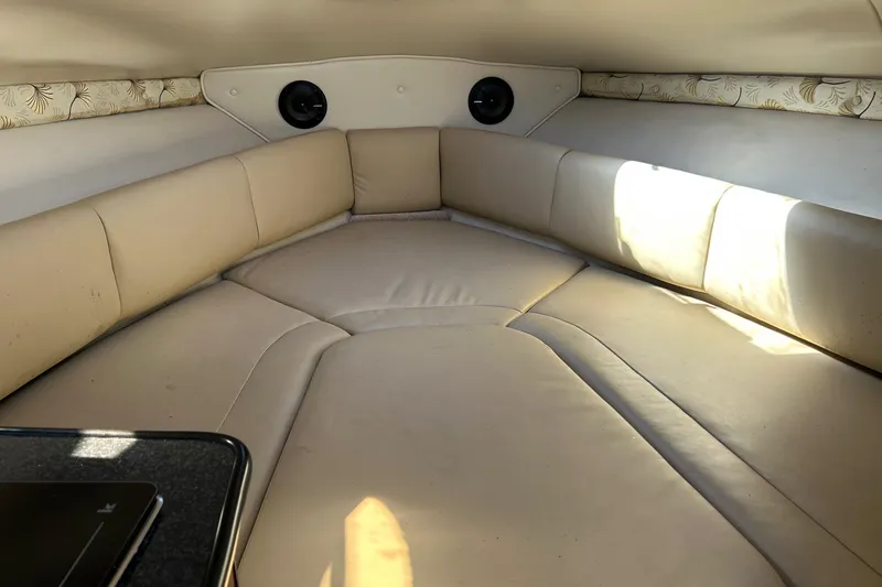 Slide: The Image of Interior cabin of 2001 Chaparral Signature 240 boat with beige seating and floral accents. - 29