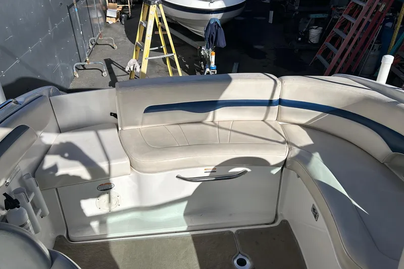 Slide: The Image of 2001 Chaparral 235 SSi boat interior with beige seating and blue accents. - 10