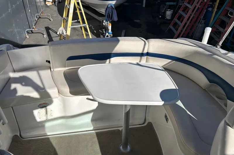 Slide: The Image of 2001 Chaparral 235 SSi boat interior with seating and table setup. - 11