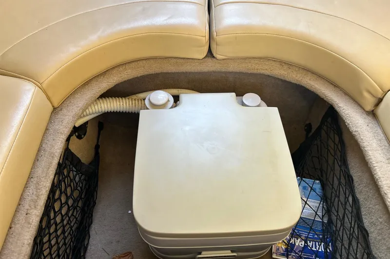 Slide: The Image of Interior of a 2001 Chaparral 235 SSi boat showing storage compartment. - 16
