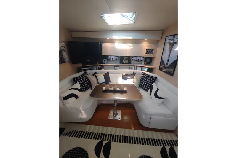 Slide: The Image of Compact kitchen in a 1995 Tiara Yachts 4300 Open, featuring modern appliances and sleek cabinetry. - 10