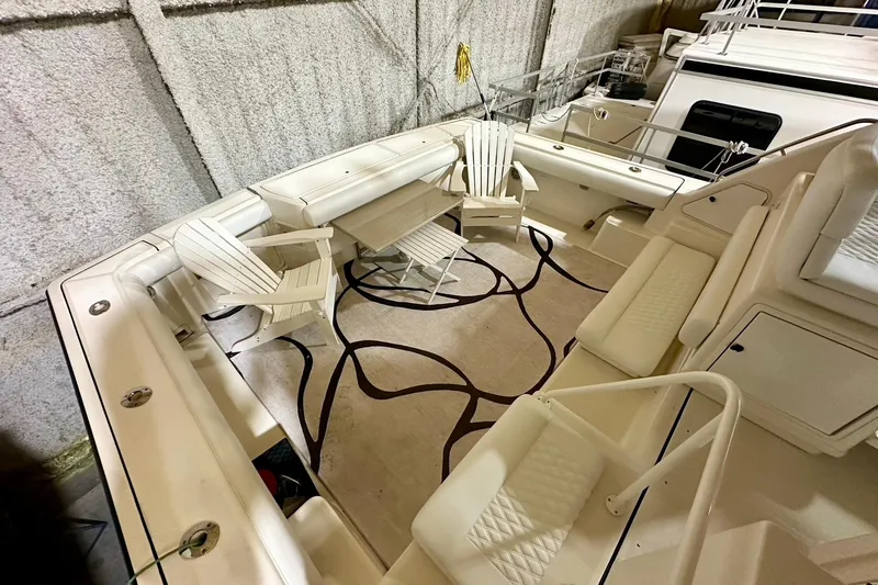 Slide: The Image of Spacious deck of 1995 Tiara Yachts 4300 Open with seating and table setup. - 17