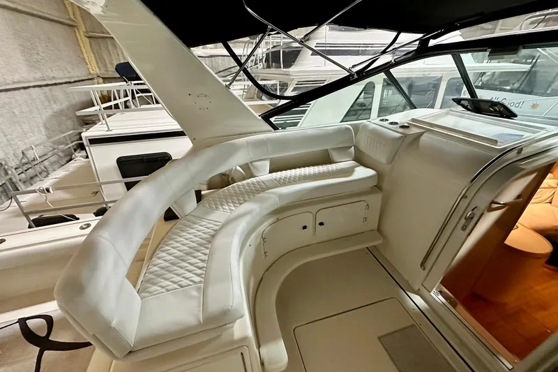 Slide: The Image of Interior view of a 1995 Tiara Yachts 4300 Open, featuring elegant white seating. - 20