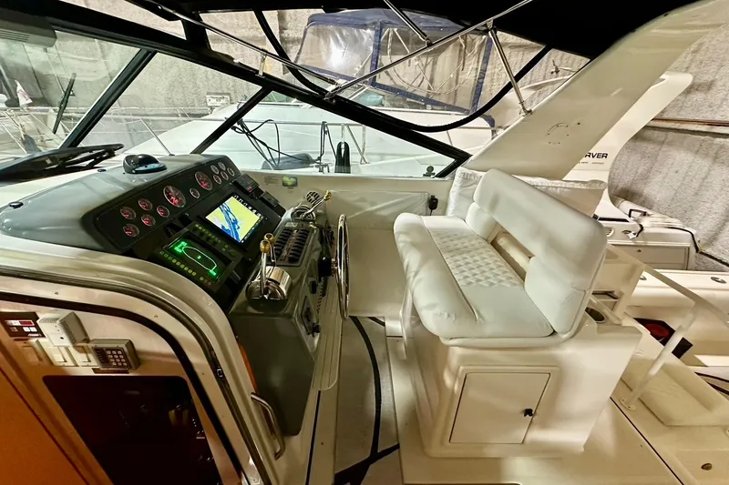 Slide: The Image of 1995 Tiara Yachts 4300 Open cockpit with modern navigation equipment and plush seating. - 22