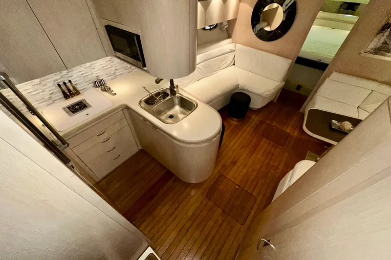 Slide: The Image of Luxurious interior of a 1995 Tiara Yachts 4300 Open, featuring a modern kitchen and seating area. - 24