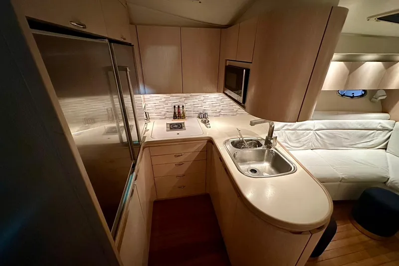 Slide: The Image of Luxurious 1995 Tiara Yachts 4300 Open interior kitchen with modern amenities and sleek design. - 25