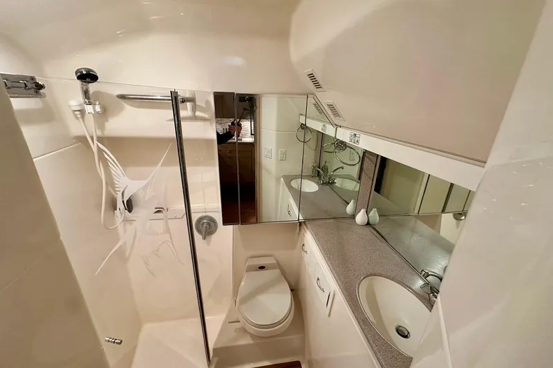 Slide: The Image of Bathroom interior of 1995 Tiara Yachts 4300 Open, featuring shower, sink, and mirror. - 26