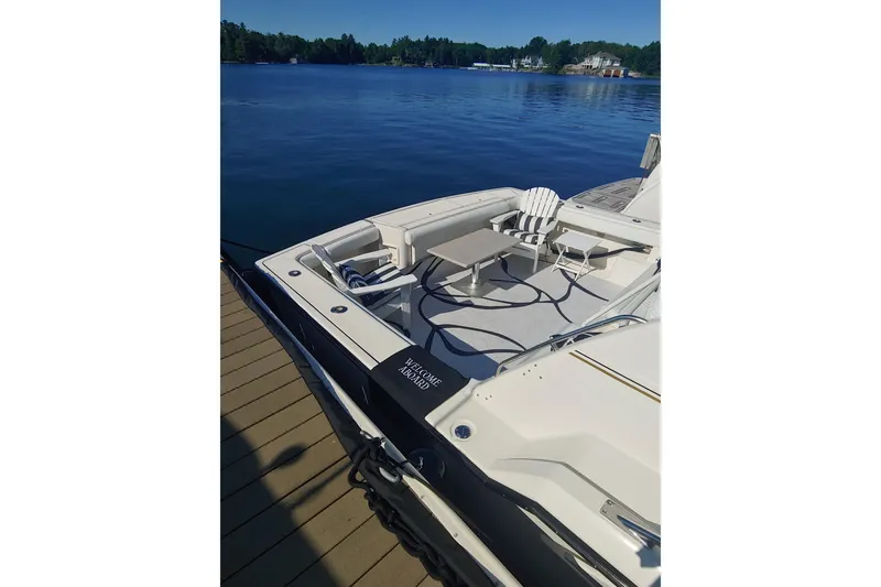 Slide: The Image of 1995 Tiara Yachts 4300 Open docked, featuring spacious deck and seating area. - 3