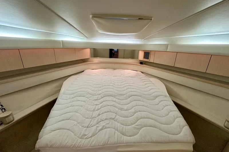Slide: The Image of Luxurious cabin interior of 1995 Tiara Yachts 4300 Open with cozy bedding. - 30