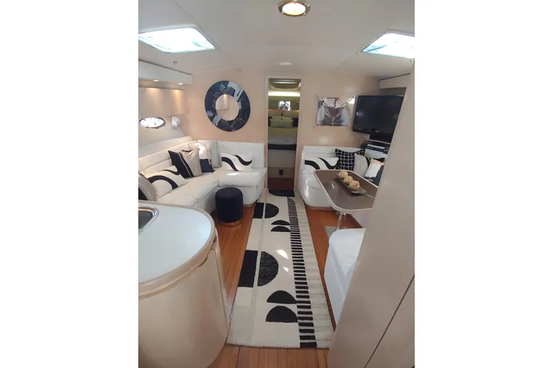 Slide: The Image of Luxurious seating area on a 1995 Tiara Yachts 4300 Open, featuring stylish cushions and scenic water views. - 7