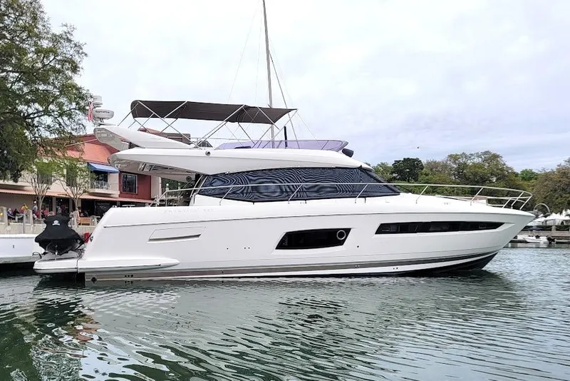 Slide: The Image of Luxurious 2014 Prestige 550 yacht bedroom with elegant decor and cozy seating area. - 10
