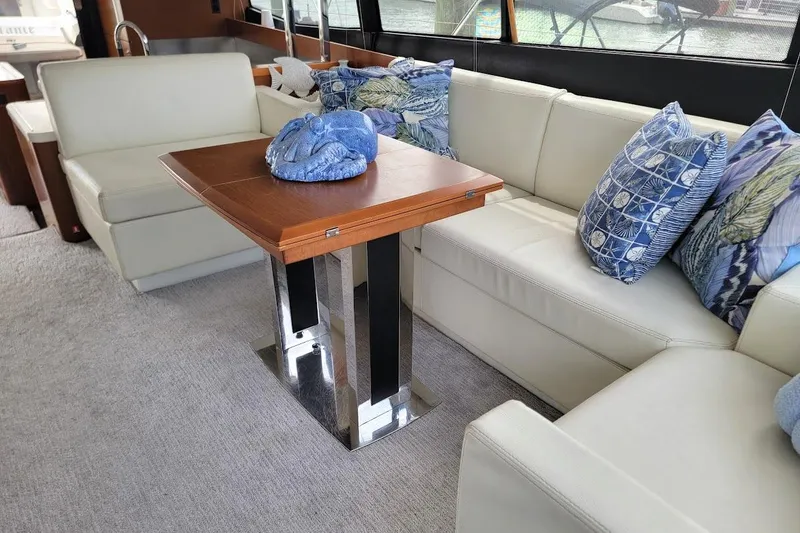 Slide: The Image of Luxurious cabin interior of a 2014 Prestige 550 yacht with elegant bedding and wood accents. - 15