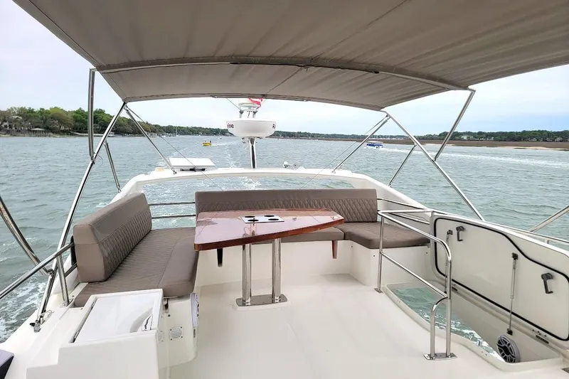 Slide: The Image of Luxurious 2014 Prestige 550 yacht bedroom with fish-patterned blanket and elegant decor. - 31