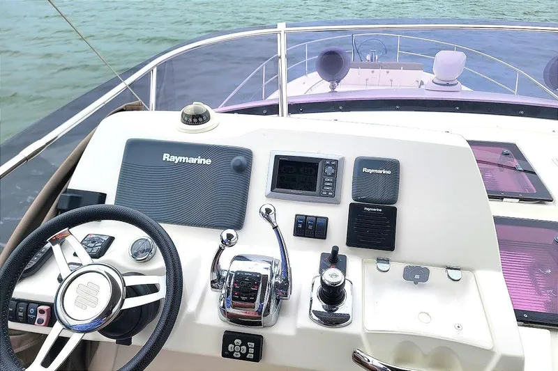 Slide: The Image of Cockpit of 2014 Prestige 550 yacht with navigation screens and controls. - 4