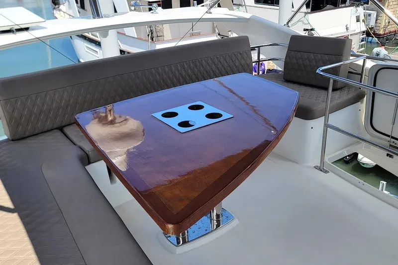 Slide: The Image of Luxurious seating area on a 2014 Prestige 550 yacht with polished wooden table. - 49