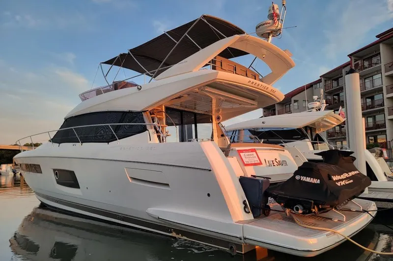 Slide: The Image of Luxury 2014 Prestige 550 yacht docked at marina during sunset. - 56