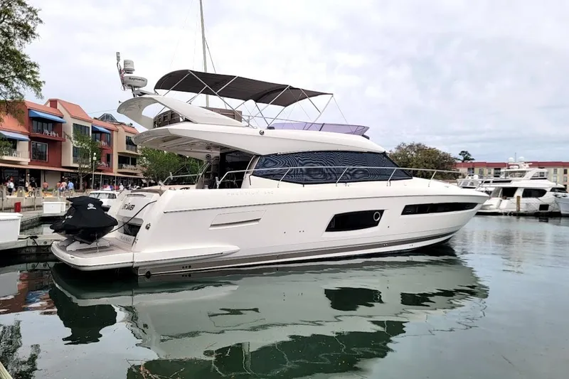Slide: The Image of 2014 Prestige 550 yacht helm with Raymarine navigation system and dual throttle controls. - 6