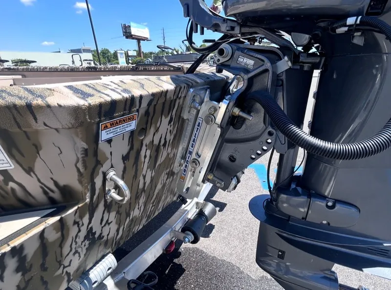 Slide: The Image of Avid 16 Commander 2026 boat with outboard motor and camouflage pattern. - 10