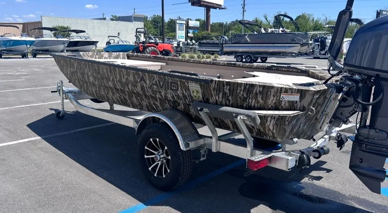 Slide: The Image of Avid 16 Commander 2026 boat on trailer outdoors. - 5